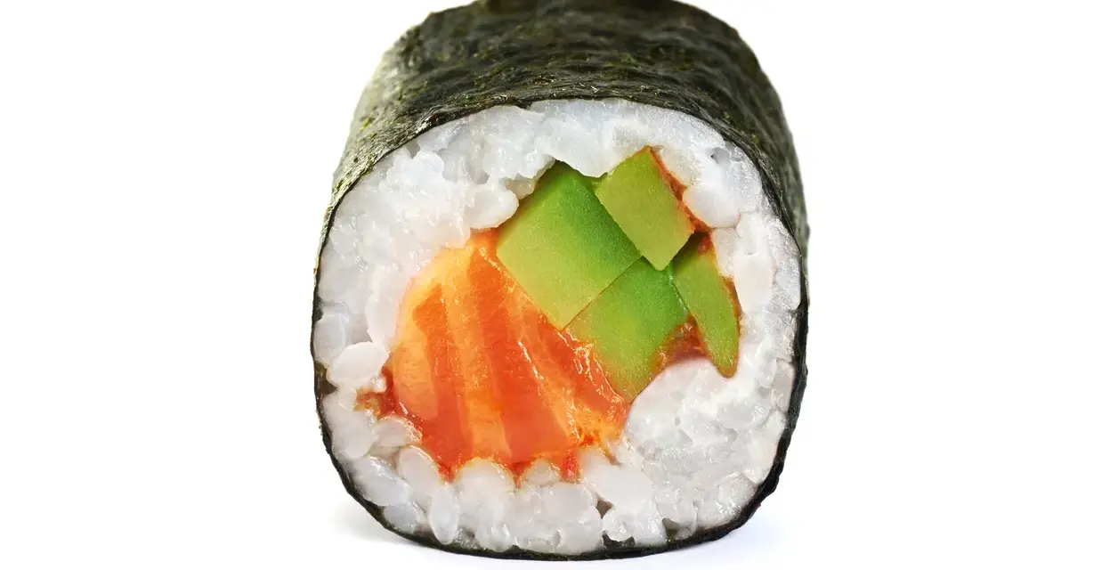 Rolka sushi z łososiem i awokado. Zastanawiasz się, ile waży sushi? Ta porcja jest idealna na przekąskę.